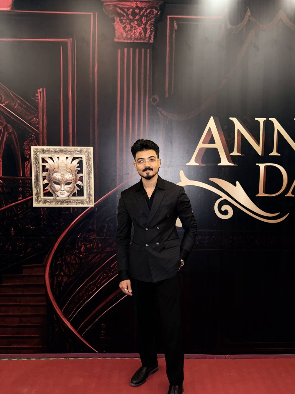 Rudrangshu Tarafder in a black suit at a formal Annual Day event